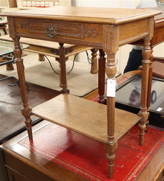 A carved oak two tier side table W.70cm